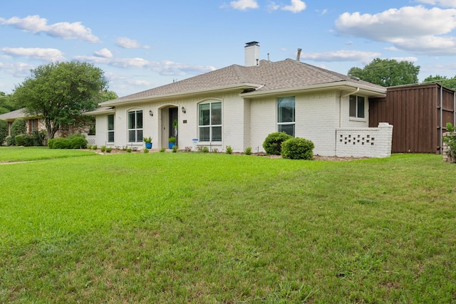 328 High Brook Dr, Richardson, TX 75080 - back of property featuring a chimney, brick siding, a lawn, and roof with shingles