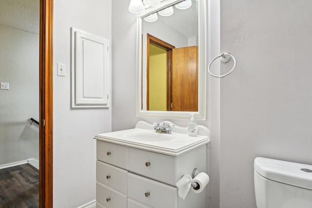 3801 Silver Maple Dr, Carrollton, TX 75007 - half bathroom with vanity and wood finished floors