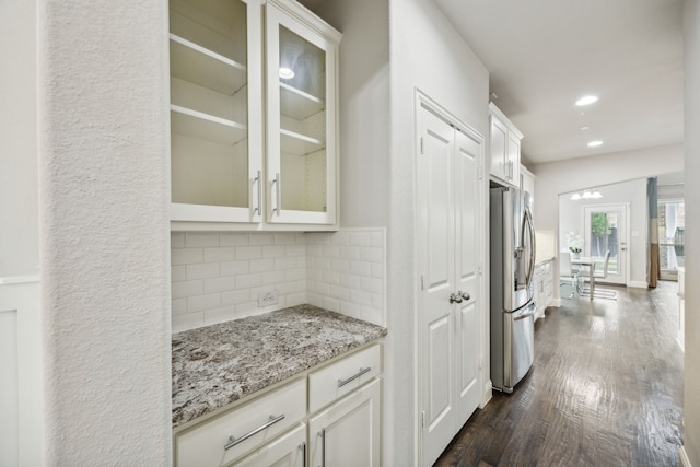 5024 Amande Ave, Lewisville, TX 75056 - kitchen with stainless steel fridge with ice dispenser, dark wood-style flooring, decorative backsplash, light stone counters, and glass insert cabinets