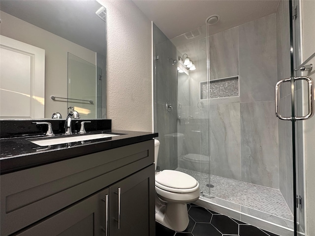 5024 Amande Ave, Lewisville, TX 75056 - full bathroom featuring tile patterned floors, toilet, a shower stall, vanity, and a textured wall