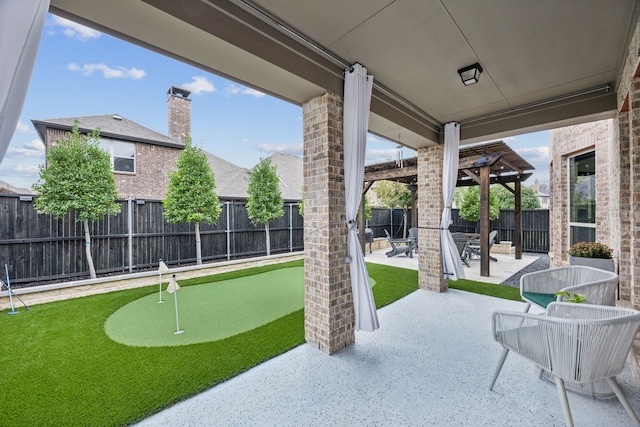 5024 Amande Ave, Lewisville, TX 75056 - fenced backyard featuring a putting green and a patio area