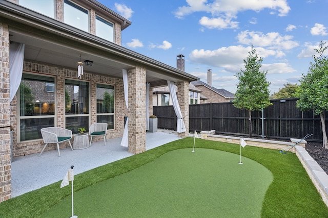 5024 Amande Ave, Lewisville, TX 75056 - fenced backyard with a putting green and a patio area
