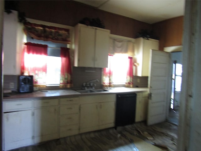 507 N Beaton St, Corsicana, TX 75110 - kitchen with a sink, white cabinetry, and tasteful backsplash
