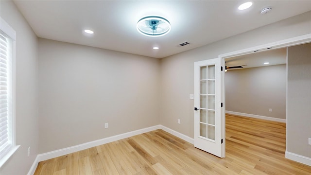 2210 Mcclure St, Irving, TX 75062 - unfurnished room with light wood finished floors, a smoke detector, baseboards, french doors, and recessed lighting