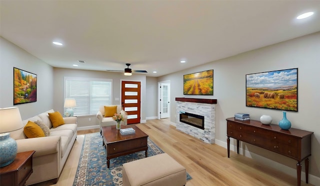 2210 Mcclure St, Irving, TX 75062 - living area featuring light wood-type flooring, recessed lighting, a glass covered fireplace, baseboards, and a ceiling fan