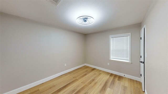 2210 Mcclure St, Irving, TX 75062 - spare room featuring baseboards and light wood finished floors