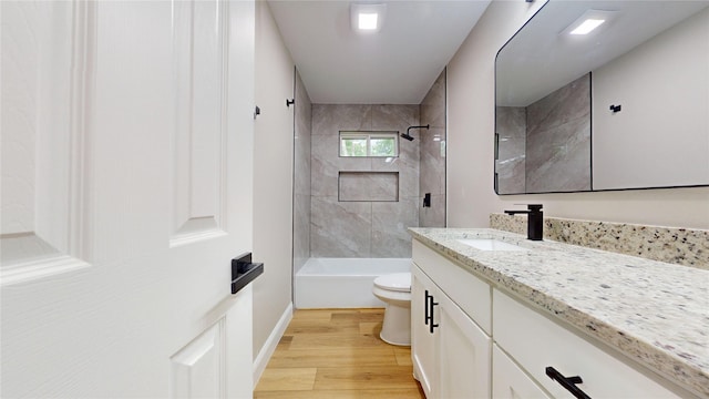 2210 Mcclure St, Irving, TX 75062 - bathroom with toilet, vanity, wood finished floors, tub / shower combination, and baseboards