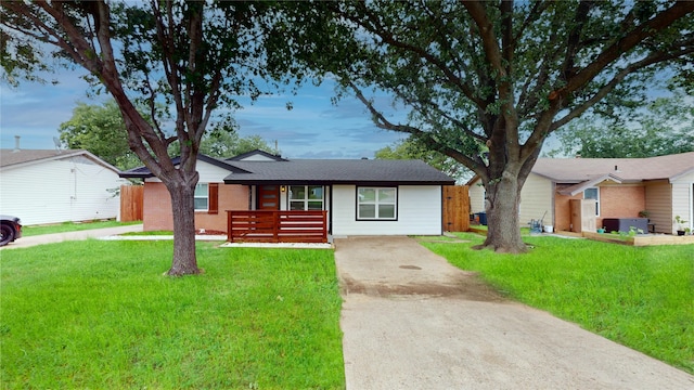 2210 Mcclure St, Irving, TX 75062 - single story home with concrete driveway, a front yard, brick siding, and roof with shingles