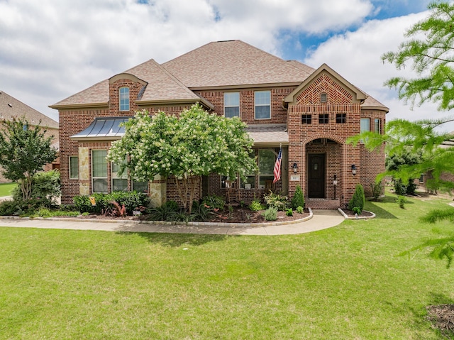 817 Calm Crest Dr, Rockwall, TX 75087 - french country home featuring brick siding, a shingled roof, a front lawn, and a standing seam roof