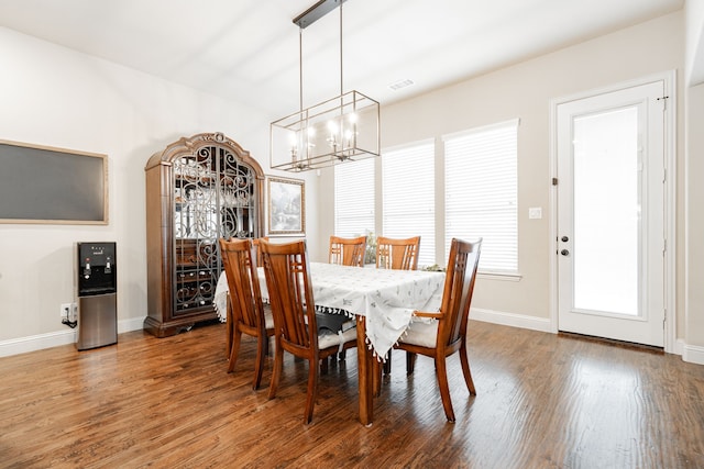 817 Calm Crest Dr, Rockwall, TX 75087 - dining room with a chandelier, wood finished floors, and baseboards