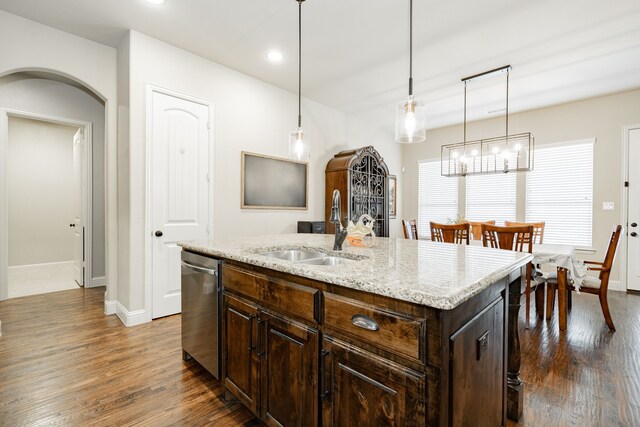 817 Calm Crest Dr, Rockwall, TX 75087 - kitchen with a sink, arched walkways, stainless steel dishwasher, dark wood-type flooring, and baseboards