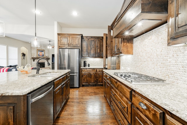817 Calm Crest Dr, Rockwall, TX 75087 - kitchen with appliances with stainless steel finishes, a sink, custom exhaust hood, dark wood-style floors, and backsplash