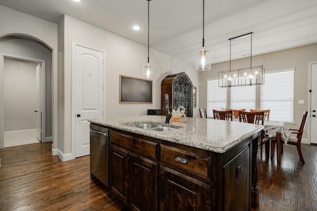 817 Calm Crest Dr, Rockwall, TX 75087 - kitchen featuring dark wood-style floors, arched walkways, dishwasher, dark brown cabinetry, and pendant lighting
