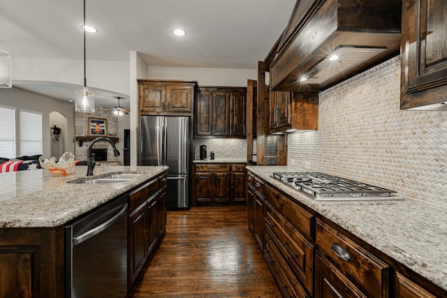 817 Calm Crest Dr, Rockwall, TX 75087 - kitchen featuring stainless steel appliances, custom range hood, dark wood-style floors, backsplash, and light stone countertops