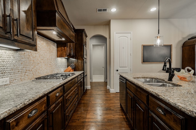 817 Calm Crest Dr, Rockwall, TX 75087 - kitchen with custom exhaust hood, arched walkways, appliances with stainless steel finishes, dark wood finished floors, and backsplash