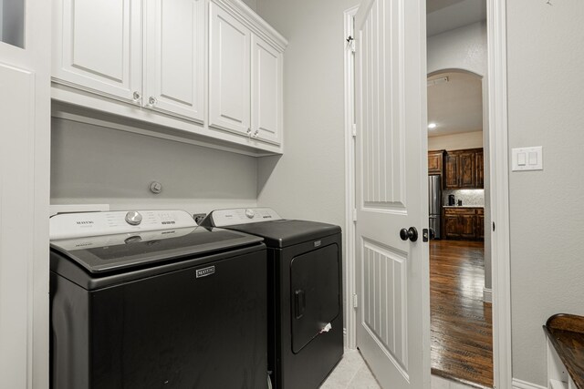 817 Calm Crest Dr, Rockwall, TX 75087 - laundry area with independent washer and dryer, cabinet space, and light wood-type flooring