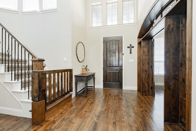 817 Calm Crest Dr, Rockwall, TX 75087 - entrance foyer featuring a towering ceiling, wood finished floors, stairway, and baseboards