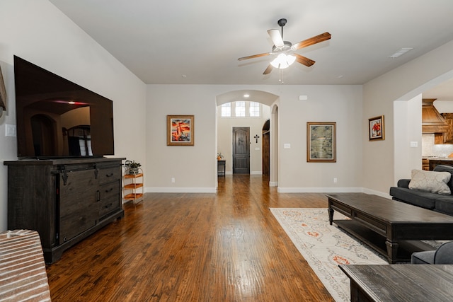 817 Calm Crest Dr, Rockwall, TX 75087 - living area featuring arched walkways, a ceiling fan, wood finished floors, and baseboards