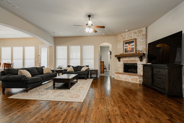 817 Calm Crest Dr, Rockwall, TX 75087 - living room with ceiling fan, wood finished floors, a fireplace, and arched walkways