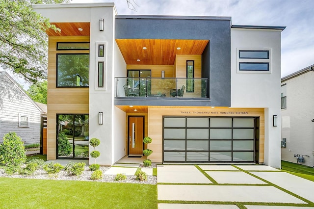3916 W 5th St, Fort Worth, TX 76107 - modern home featuring stucco siding, a balcony, driveway, and a garage