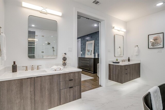 3916 W 5th St, Fort Worth, TX 76107 - full bathroom featuring two vanities, marble finish floors, a shower, baseboards, and recessed lighting