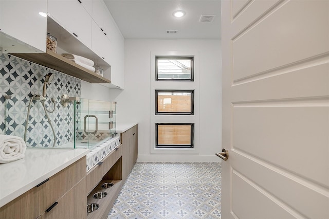3916 W 5th St, Fort Worth, TX 76107 - bathroom featuring a stall shower, tile patterned floors, vanity, and baseboards