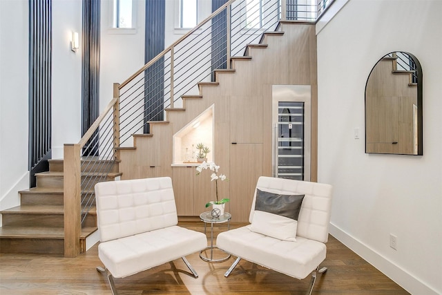 3916 W 5th St, Fort Worth, TX 76107 - sitting room with stairway, a high ceiling, baseboards, and wood finished floors