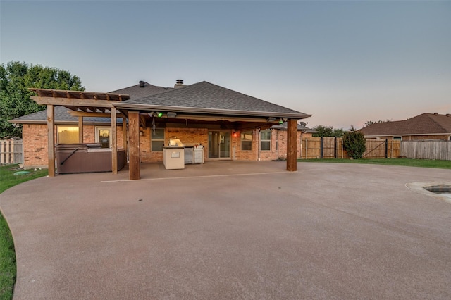 10260 E Rancho Diego Ln, Crowley, TX 76036 - back of property with a hot tub, a fenced backyard, area for grilling, brick siding, and a patio