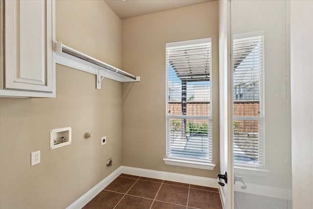 13929 Castlegate Dr, Frisco, TX 75035 - laundry area featuring electric dryer hookup, hookup for a washing machine, baseboards, dark tile patterned floors, and cabinet space