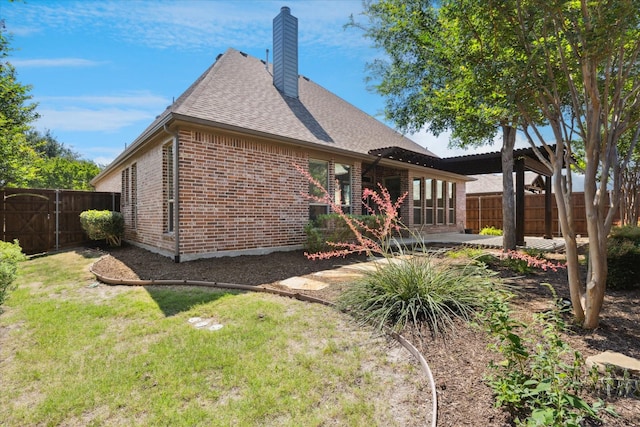 13929 Castlegate Dr, Frisco, TX 75035 - back of property with brick siding, a chimney, a patio area, and a shingled roof