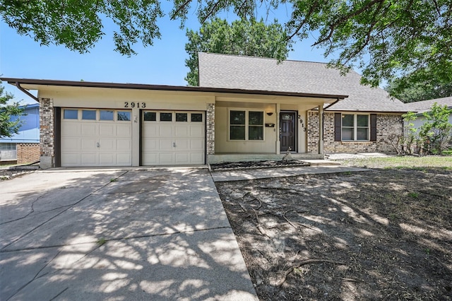 2913 Portales Dr, Fort Worth, TX 76116 - view of front of home featuring a garage, concrete driveway, and roof with shingles