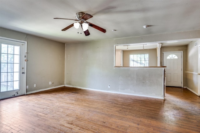 711 W State St, Terrell, TX 75160 - unfurnished room with hardwood / wood-style floors, a ceiling fan, and baseboards