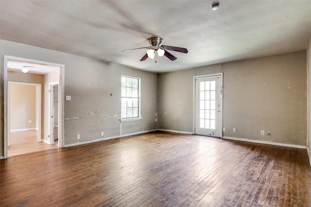 711 W State St, Terrell, TX 75160 - unfurnished room featuring ceiling fan, plenty of natural light, hardwood / wood-style flooring, and baseboards