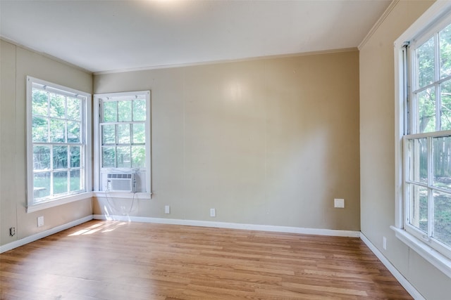 711 W State St, Terrell, TX 75160 - empty room featuring healthy amount of natural light, wood finished floors, and ornamental molding