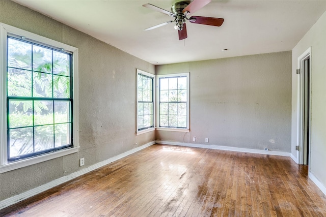 711 W State St, Terrell, TX 75160 - spare room featuring wood-type flooring, a ceiling fan, a textured wall, and baseboards