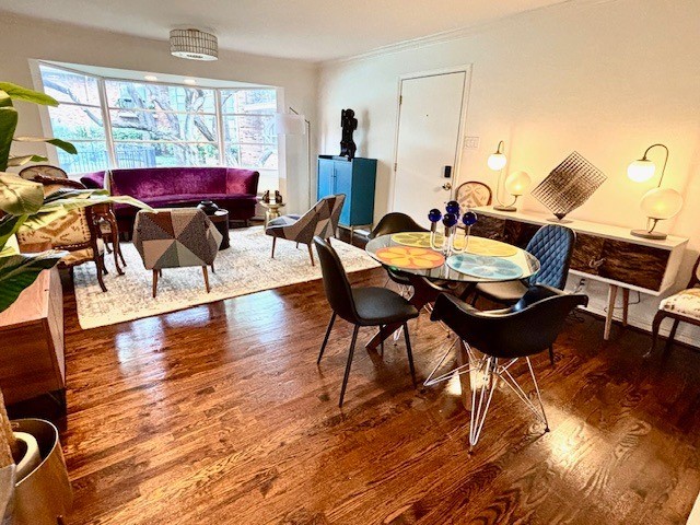 6112 Averill Way Unit B, Dallas, TX 75225 - dining area featuring wood finished floors and crown molding