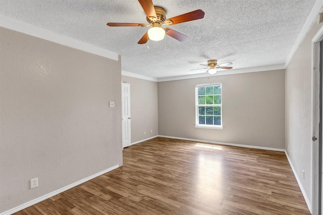 616 Bellevue Dr, Cleburne, TX 76033 - spare room with a textured ceiling, ceiling fan, wood finished floors, baseboards, and ornamental molding