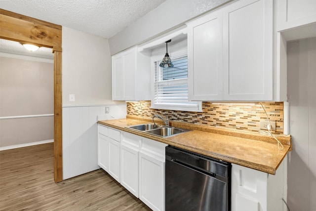 616 Bellevue Dr, Cleburne, TX 76033 - kitchen featuring stainless steel dishwasher, a sink, a textured ceiling, light wood-type flooring, and white cabinets