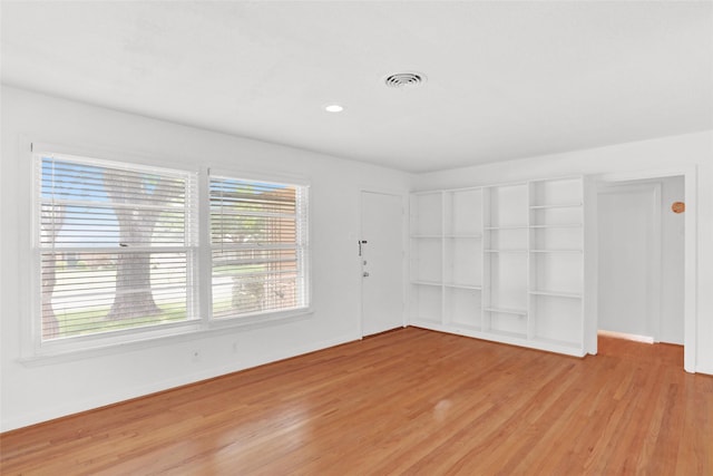 10533 Solta Dr, Dallas, TX 75218 - unfurnished room with light wood-style floors and baseboards