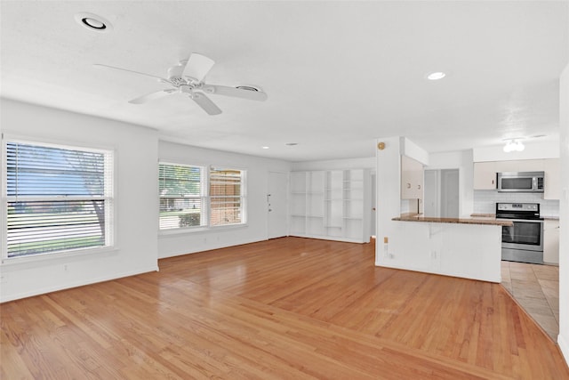 10533 Solta Dr, Dallas, TX 75218 - unfurnished living room featuring light wood-type flooring, ceiling fan, baseboards, and recessed lighting