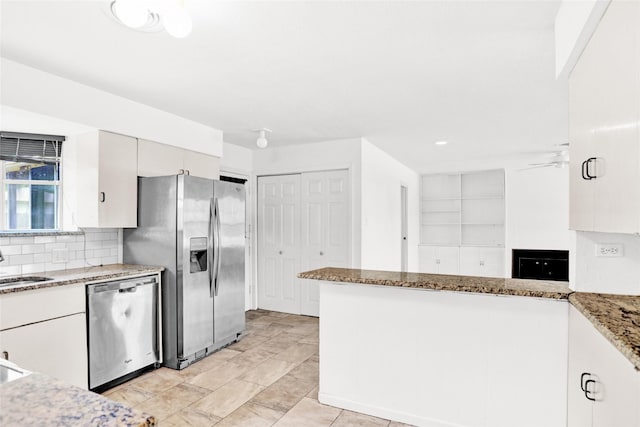 10533 Solta Dr, Dallas, TX 75218 - kitchen with stainless steel appliances, light stone countertops, a ceiling fan, backsplash, and a sink