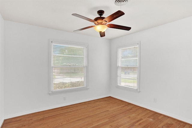 10533 Solta Dr, Dallas, TX 75218 - spare room with light wood-style flooring, a ceiling fan, and baseboards