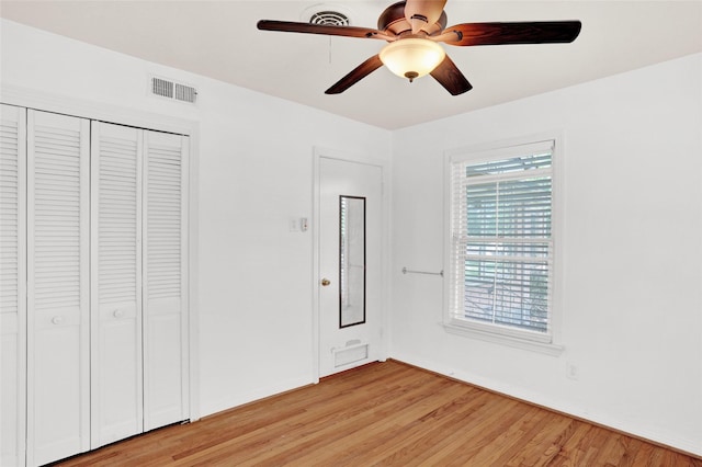 10533 Solta Dr, Dallas, TX 75218 - unfurnished bedroom with light wood-type flooring, a closet, and ceiling fan