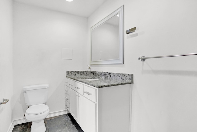 10533 Solta Dr, Dallas, TX 75218 - half bath with toilet, vanity, and baseboards