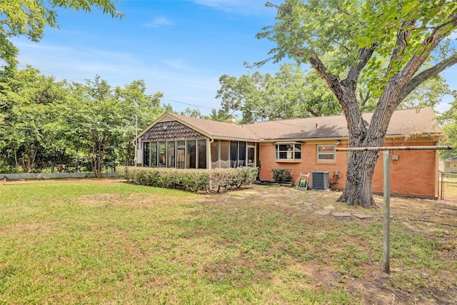 10533 Solta Dr, Dallas, TX 75218 - back of house featuring central AC unit, a sunroom, a yard, and brick siding