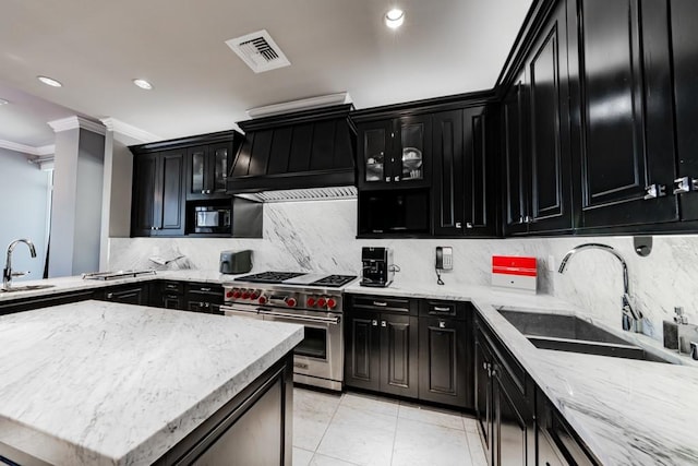 2525 N Pearl St Unit 1704, Dallas, TX 75201 - kitchen with dark cabinetry, luxury range, premium range hood, ornamental molding, and decorative backsplash