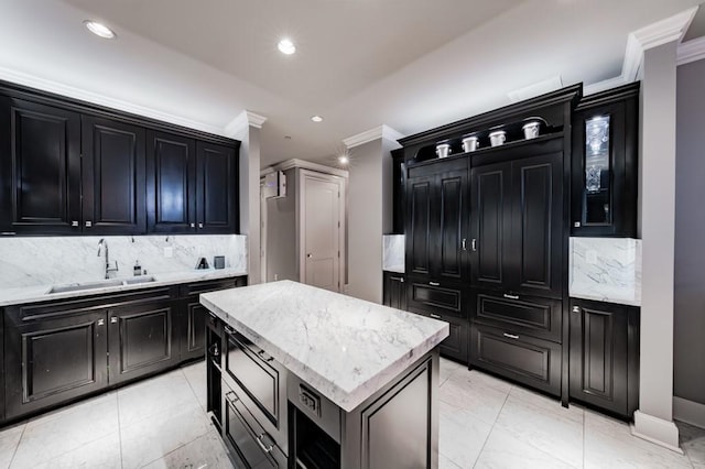 2525 N Pearl St Unit 1704, Dallas, TX 75201 - kitchen featuring dark cabinetry, a sink, ornamental molding, backsplash, and recessed lighting