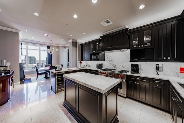 2525 N Pearl St Unit 1704, Dallas, TX 75201 - kitchen with range with two ovens, dark cabinets, ornamental molding, custom range hood, and beverage cooler