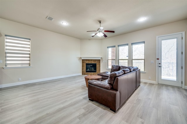 3608 Walden Dr, Mckinney, TX 75071 - living area with light wood-style flooring, a ceiling fan, a tiled fireplace, baseboards, and recessed lighting