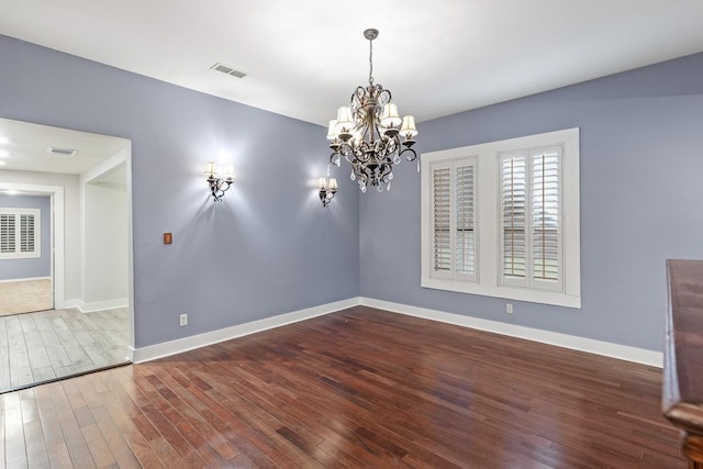 715 S Barnett Ave, Dallas, TX 75211 - unfurnished dining area with wood finished floors, a chandelier, and baseboards